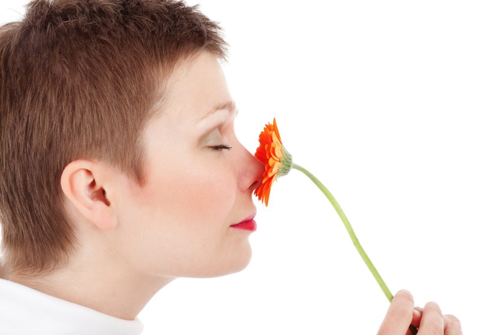 woman smelling a flower